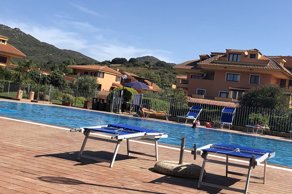 sun beds in front of a swimming pool