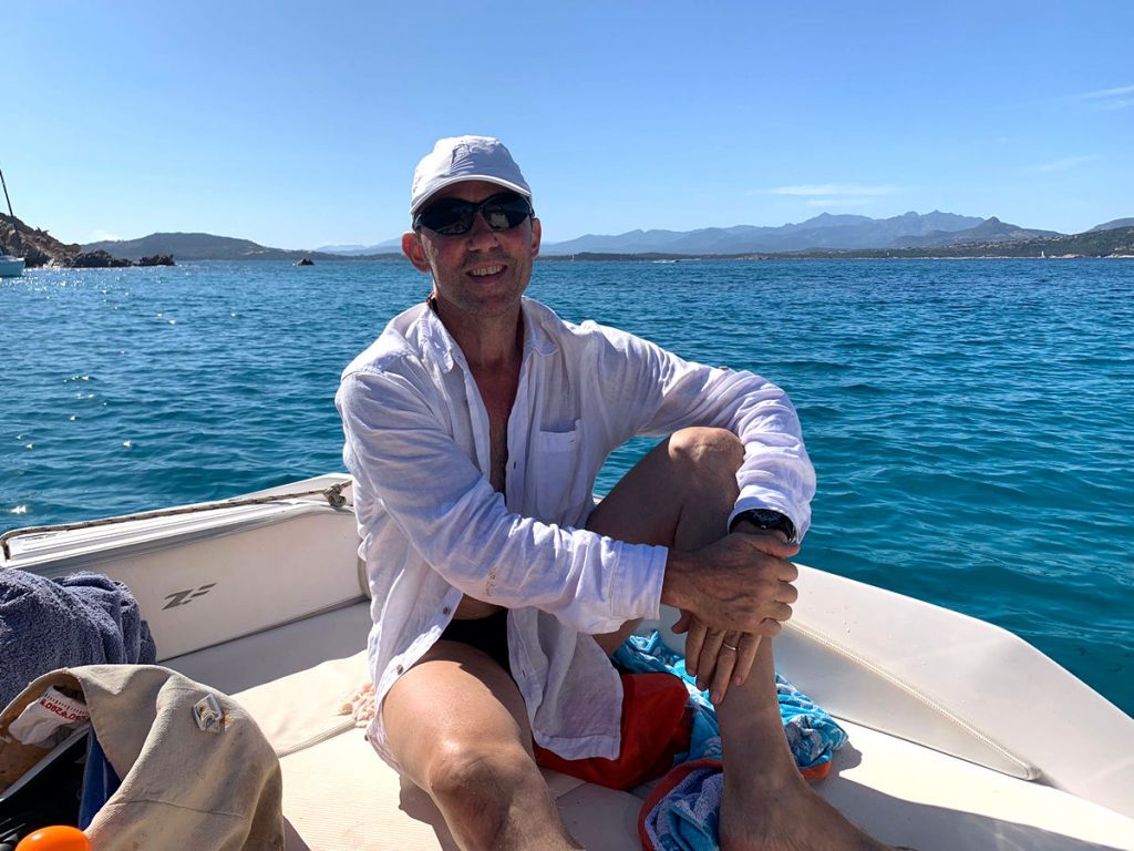 a man on boat at sea in the sun