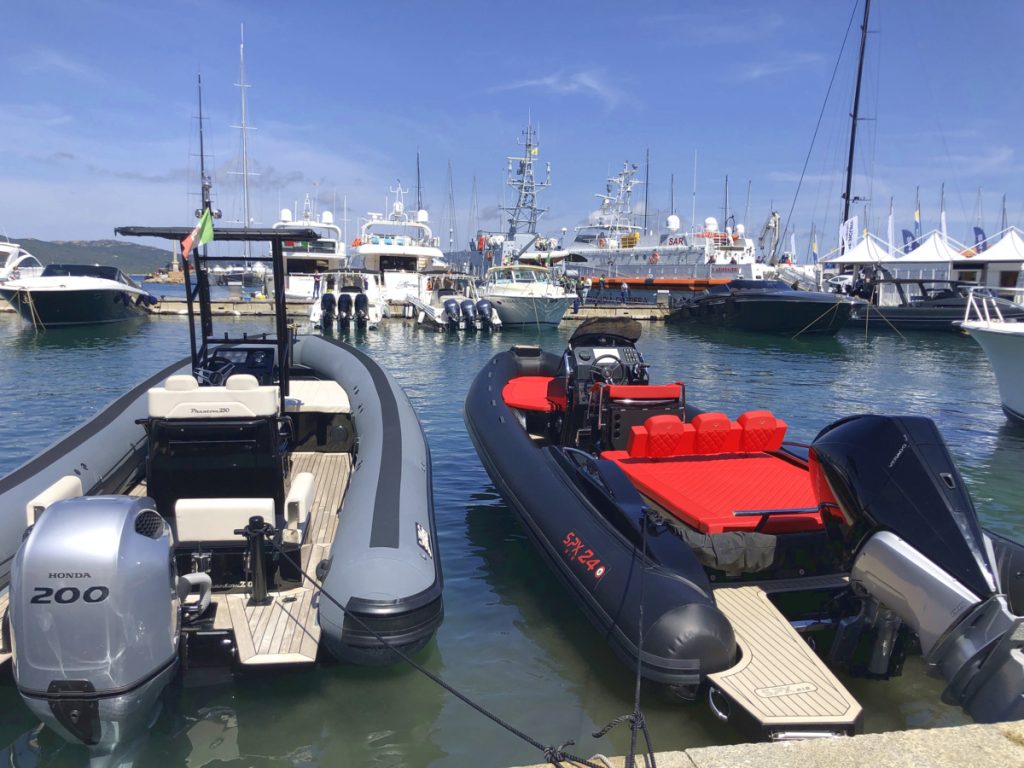 moored boats in a marina with a blue sky